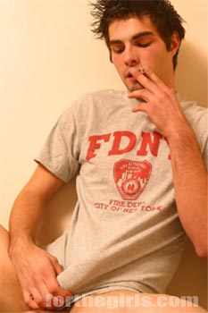 Pic: Bad boy Ashley smokes a cigarette and plays with his cock.