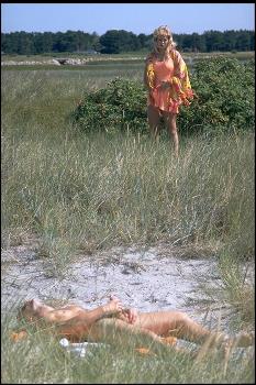 Pic: She catches him masturbating in the sand dunes at the beach. 